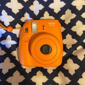 Orange Instax Mini 8 Polaroid camera